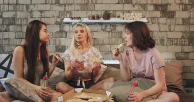 Closeup modern bir yatak odasında genç çekici bayanlar pizza bazı içecekler içme yeme ve birbirleriyle ilginç bir konuşma var, mutlu duygu ve zaman zevk