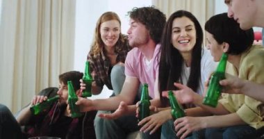 Arkadaşlar closeup grup tv önünde çok etnik içme bira ve kanepede otururken bir futbol maçı için hazır , karizmatik ve çekici gençler