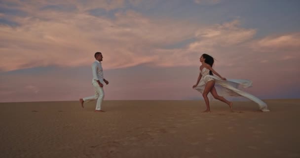 Lopen langzaam door het strand romantisch aantrekkelijk paar ze zijn verliefd bij zonsondergang — Stockvideo