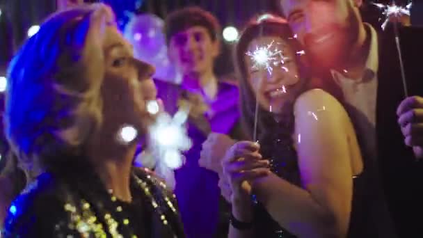 Geweldig uitziende dames met een zeer grote glimlach en aantrekkelijke jongens op het feest genieten van de sfeer waarin ze dansen en zich ontspannen voelen — Stockvideo