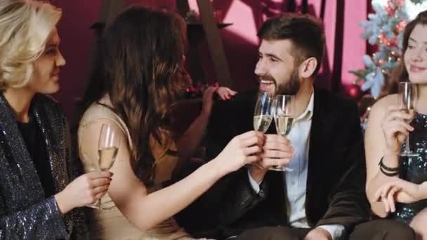 3人の美しい女性と1人の若い男性がカメラの前でクリスマスパーティーを開き、シャンパンを飲みながら興奮していました — ストック動画