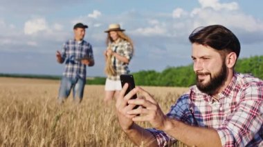Kameranın önündeki çiftçi genç adam buğday tarlasını inceliyor. Ailesi arka planda çok heyecanlı. Buğday tarlasının hasadı hakkında bir şeyler tartışıyorlar.