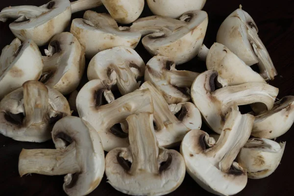 mushrooms on a black background ut champignons. Fresh to cook.