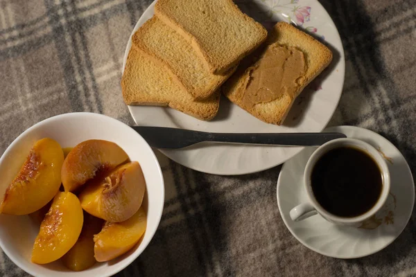 still life with coffee, peaches and toasts