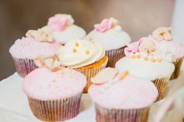 beyaz ve pembe krem ve altın parıllar ile bazı cupcakes