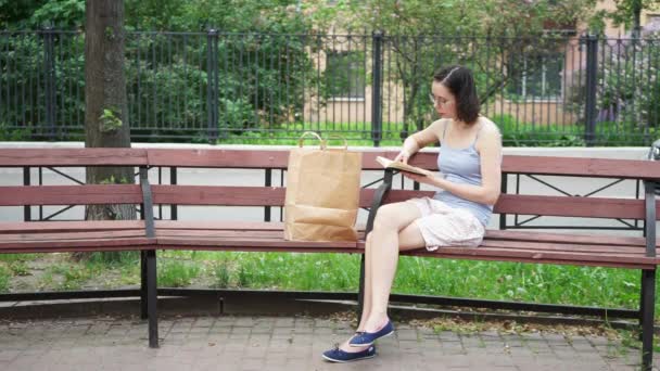 Uma Menina Sentada Banco Livro Com Lábios Movendo — Vídeo de Stock