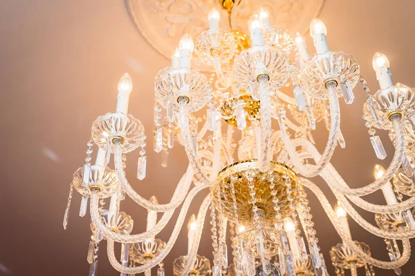 Glass lamp with chandeliers and crystals. Lustre and lighting in a classic interior
