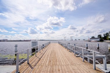 Beautiful view of wooden pier in river port of Saint-Petersburg, Russia. clipart