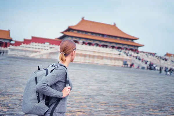 Traveling young woman with rucksack in Forbidden City, Beijing.