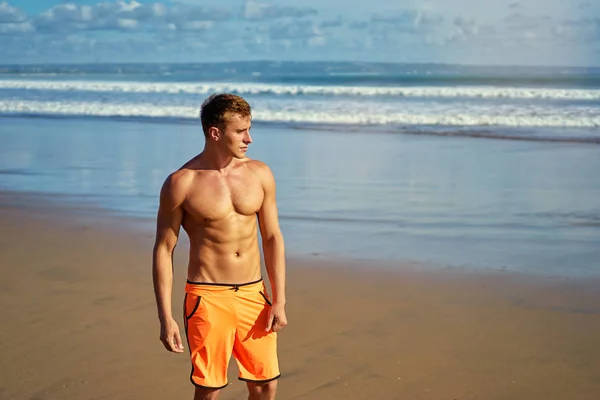 Portrait of young caucasian man on the sea beach.