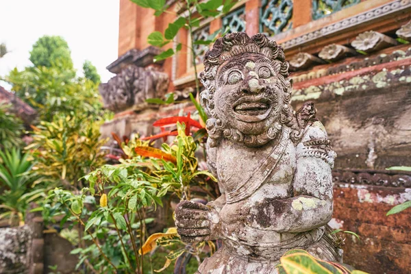 Traditional hindu statue of demon at Bali temple.