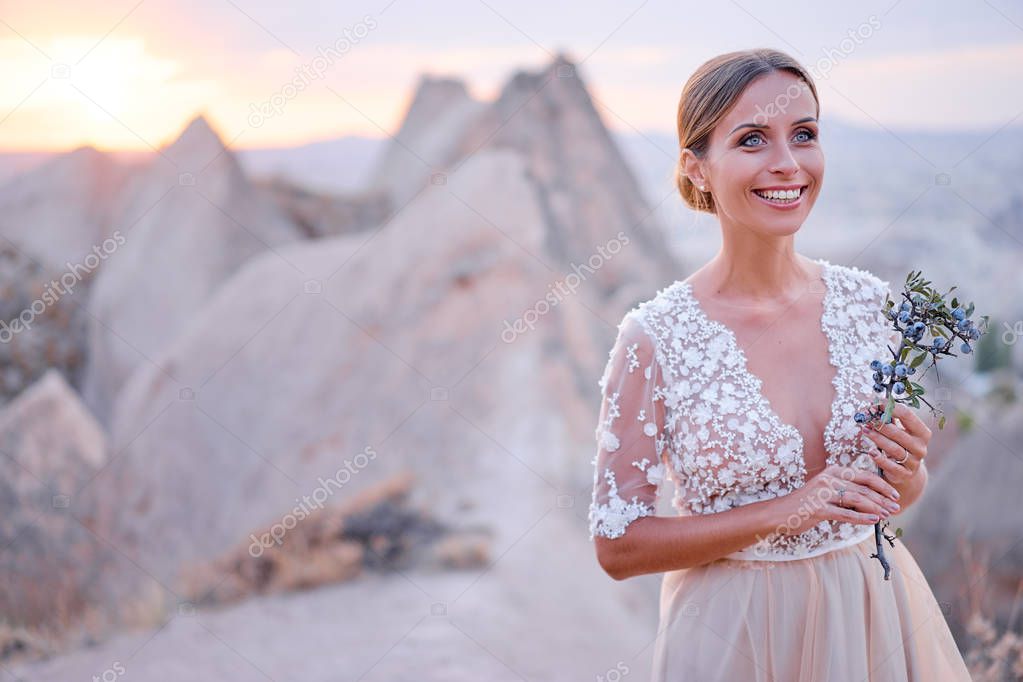 Fairy and sensual portrait of pretty young woman against mountains view.