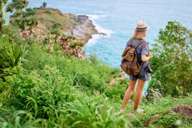 Kamera ve Deniz Manzaralı zevk sırt çantası olan seyahat kadın.