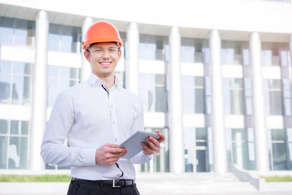 Handsome Young Man Hardhat Using Tablet Computer While Standing Outdoors — Stock Photo, Image