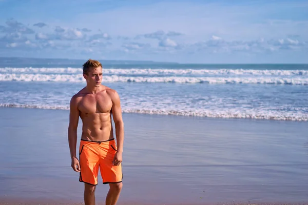 Portrait of young caucasian man on the sea beach.