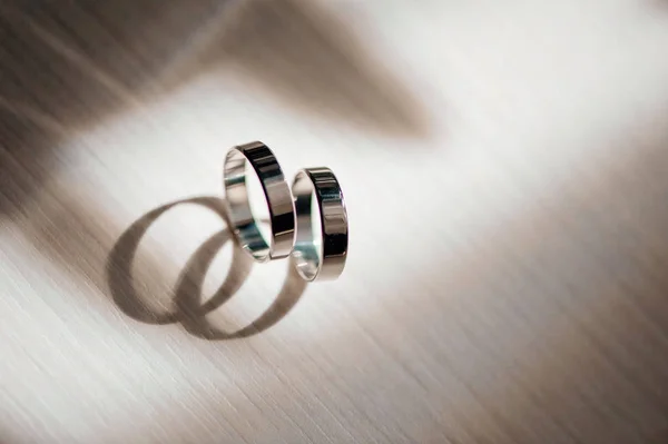 close-up view of couple of white gold wedding rings.