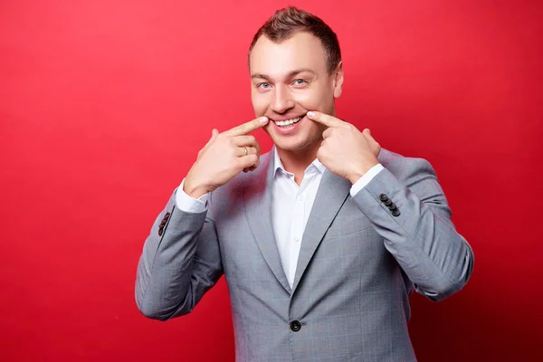 Handsome Young Business Man Keeping Smile His Fingers While Standing — Stock Photo, Image