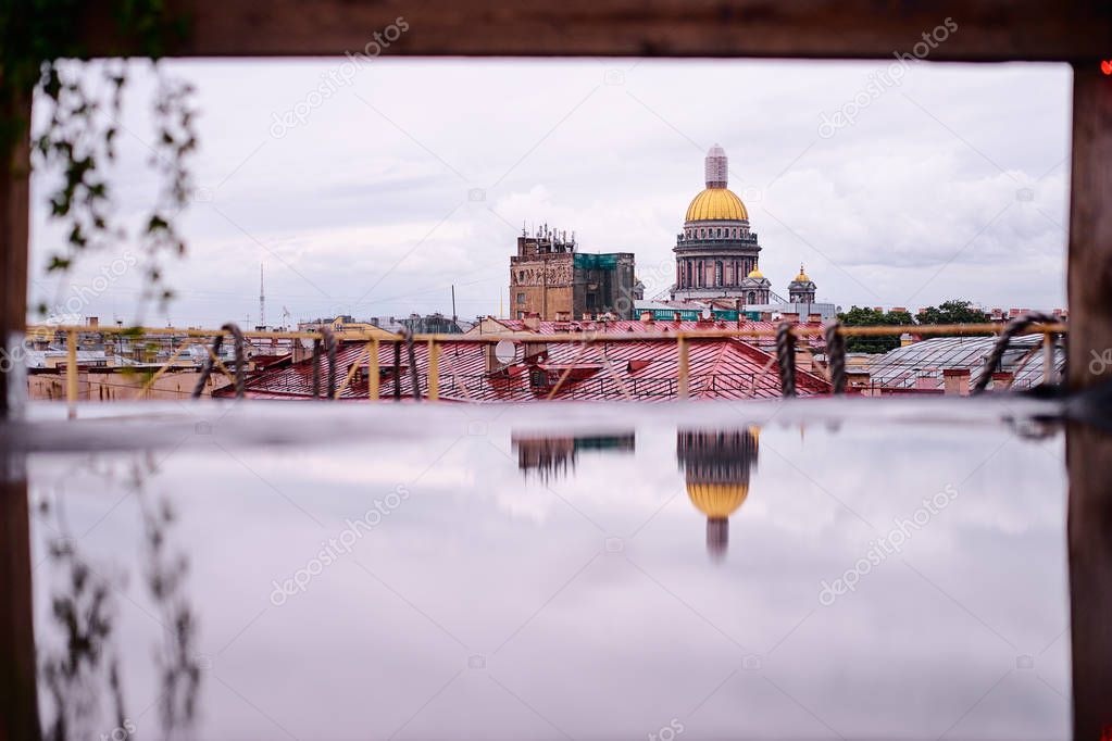 Rainy day at Saint-Petersburg, Russia. Rooftop view on old buildings and St Isaac Cathedral.