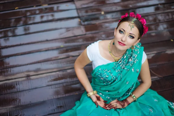 Beautiful young indian woman in traditional clothing with bridal makeup and jewelry