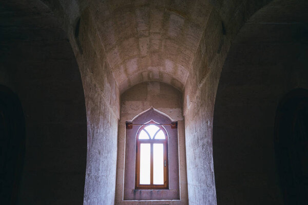  Gothic style window in castle stone wall.