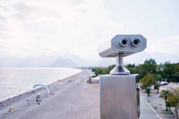 close-up view of coin Operated Binocular viewer next to the waterside promenade in Antalya looking out to the bay and city.