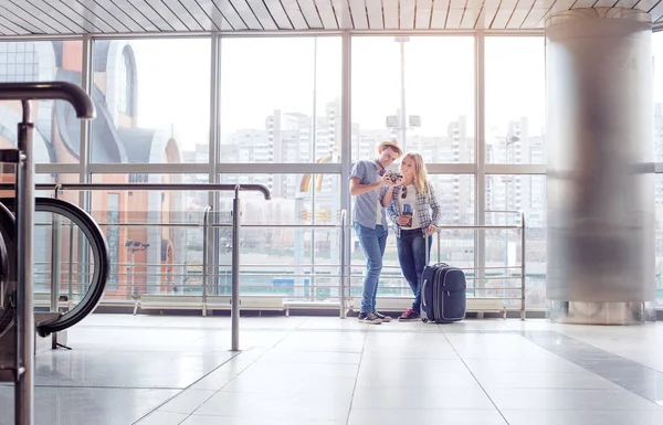 Happy Loving Couple Casual Wear Standing Airport Terminal Holding Camera — Stock Photo, Image