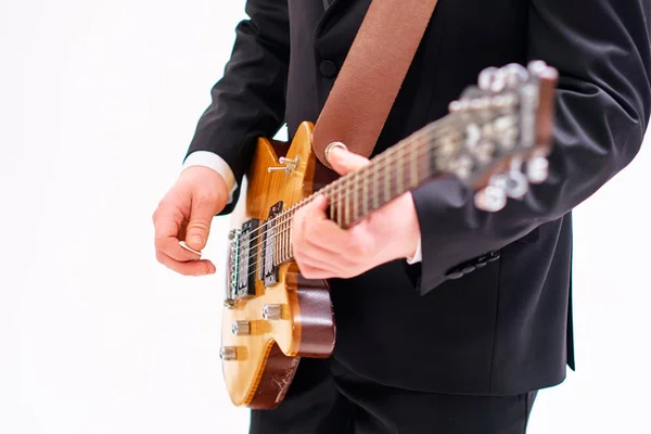 young man playing electric guitar on white background.
