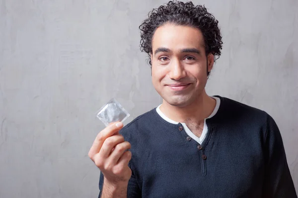 Schöner Arabischer Mann Freizeitkleidung Mit Kondom Vor Grauem Hintergrund — Stockfoto