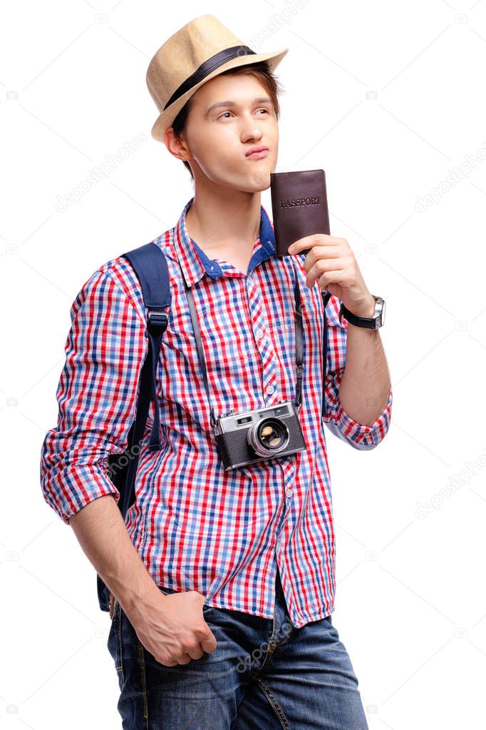 Studio portrait of thoughtful handsome young man holding passport