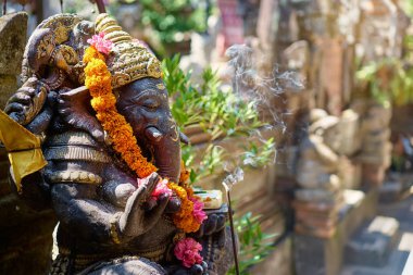 Arka çiçekli Ganesha Tanrı'nın geleneksel taş heykel. Bali, Endonezya.