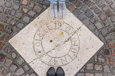 male and female feet on paving stone