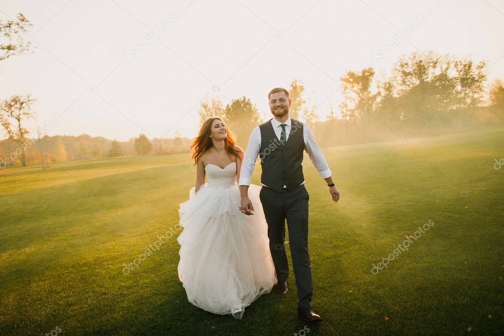 wedding couple walking in the park