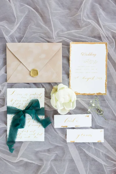 top view of wedding cards, envelope and flower