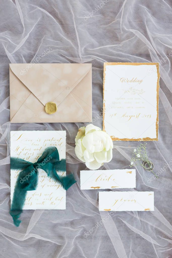 top view of wedding cards, envelope and flower 