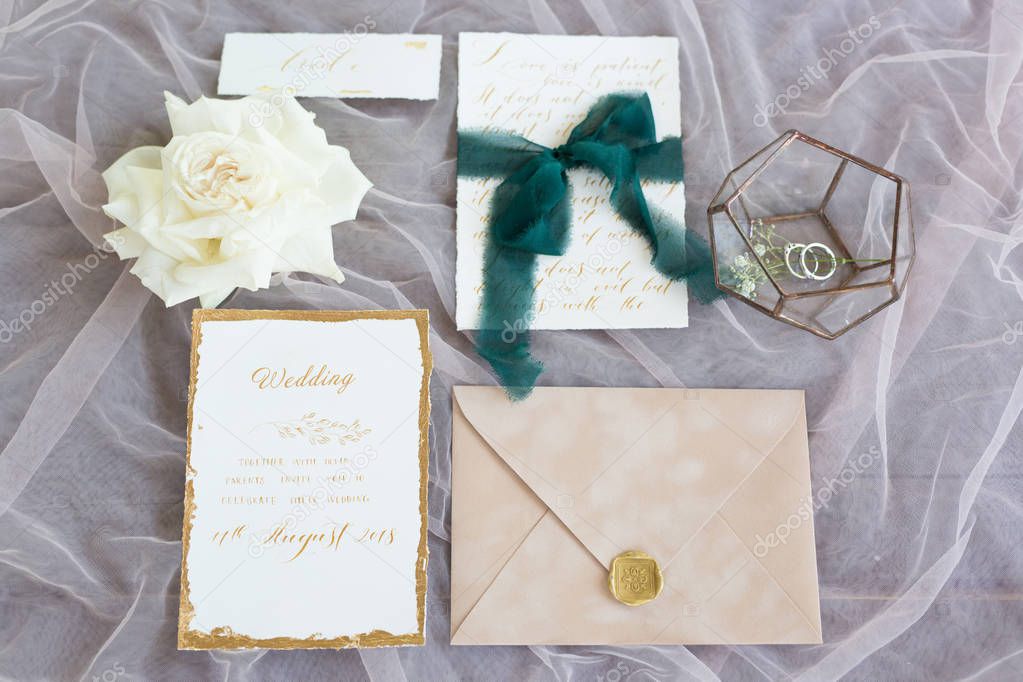 top view of wedding cards, envelope and flower 