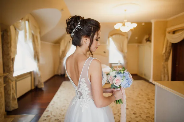 穿着灰色背景的漂亮时髦婚纱的年轻漂亮新娘的肖像 — 图库照片