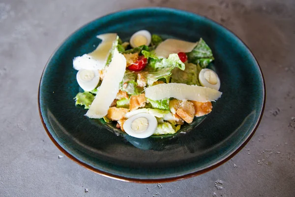 salad of eggs, spinach, cheese, pate lies on a plate in a restaurant