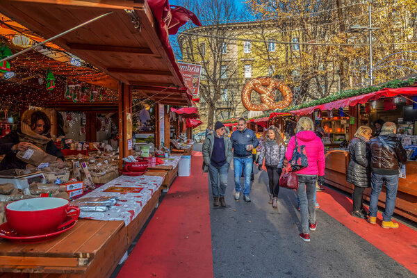 BERGAMO, ITALY - DECEMBER 12, 2016: Part of traditional Christmas fair with different toys and traditional food preparation.