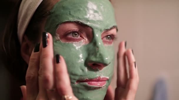 Schöne Frau mit Gesichtsmaske. Wellness-Therapie für junge Frau mit Gesichtsmaske. — Stockvideo