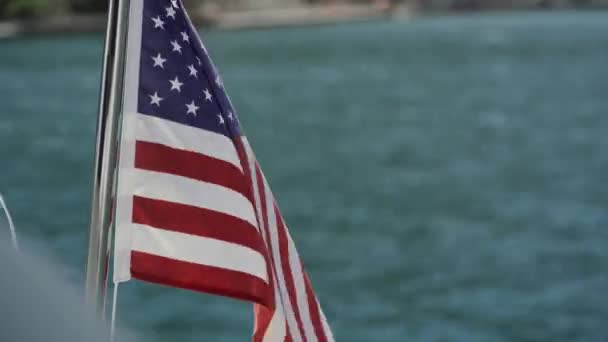 USA flagga utvecklas i vinden mot vatten i slow motion på båten — Stockvideo
