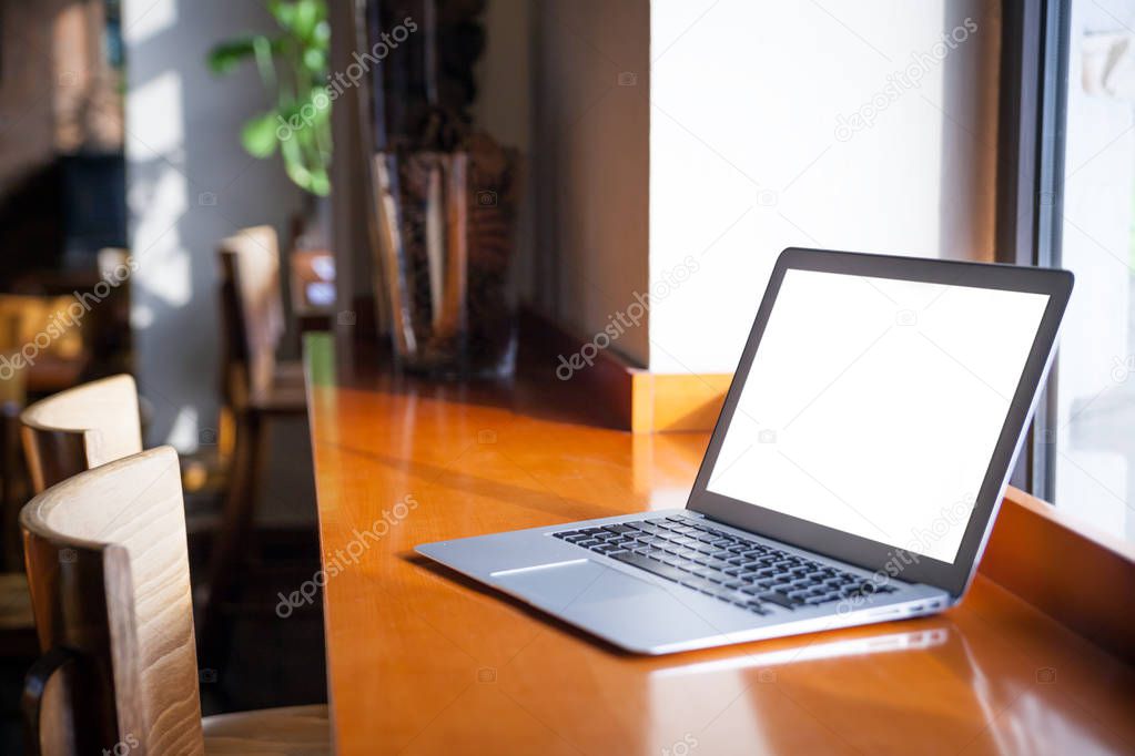 laptop with blank screen on table in cafe