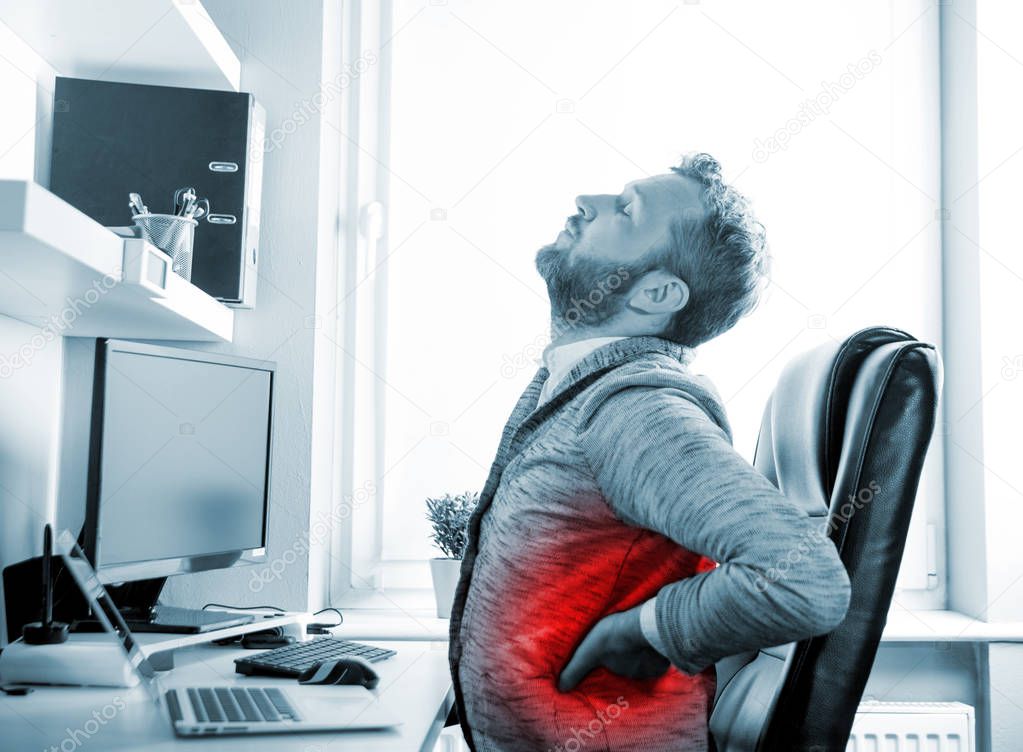 Man in desk office suffering from back pain