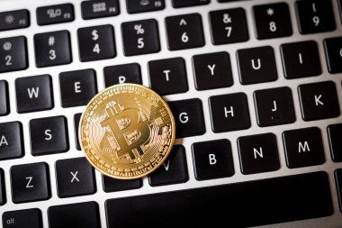 Dizüstü bilgisayar arka plan üzerinde bitcoin sikke görünümünü kapat