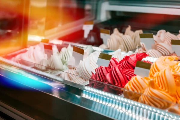 Ice cream in showcase fridge at confectionery shop