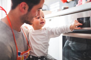 Baba ile kızı fırın ile oynama ve düğmelere basmak mutfak