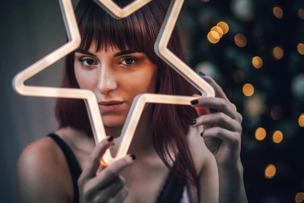 Beauty portrait of young woman with LED star light