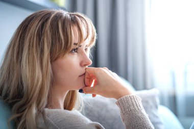 Woman at home deep in thoughts thinking and planning clipart