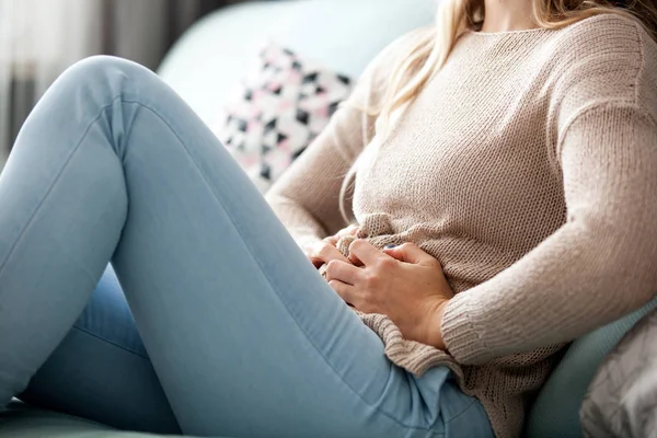 Young Woman Suffering Abdominal Pain While Sitting Sofa Home — Stock Photo, Image