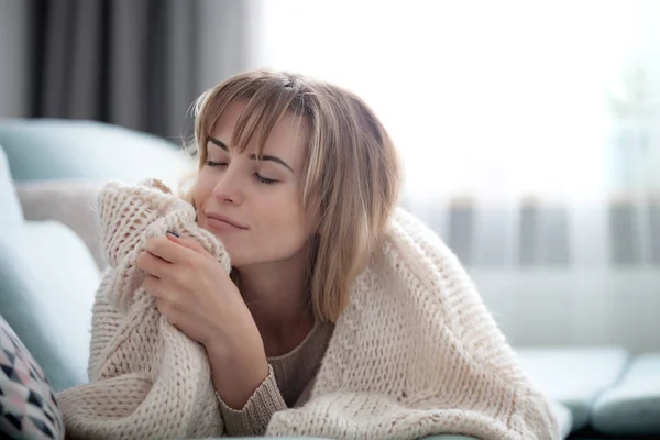 Happy Young Woman Hugging Soft Knitted Sweater Relaxing Sofa Home — Stock Photo, Image