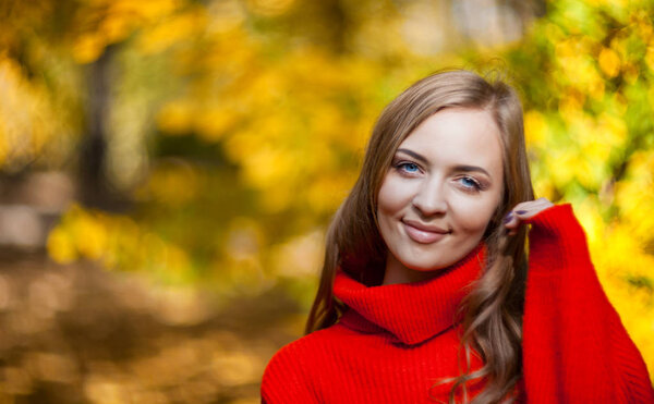 Beautiful natural woman in warm sweater on nature background